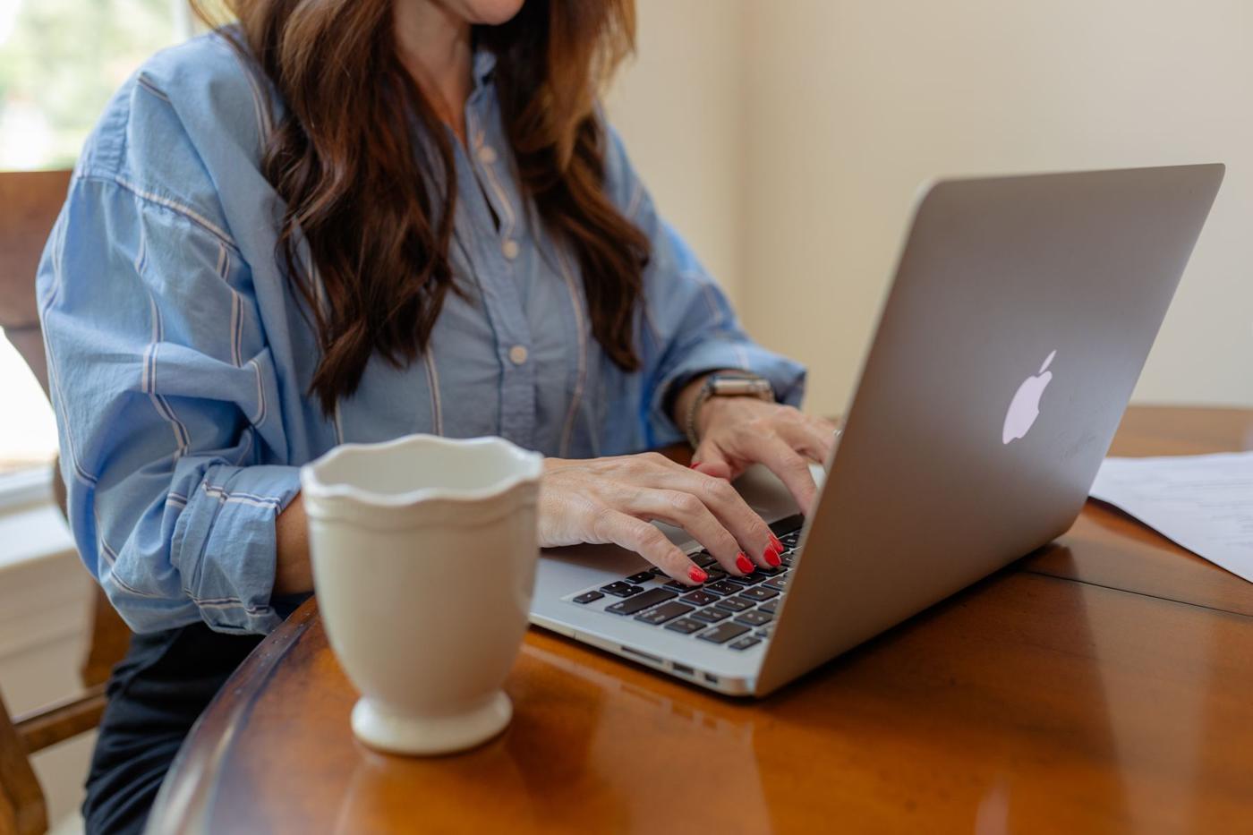 Working on a laptop with a cup of coffee
